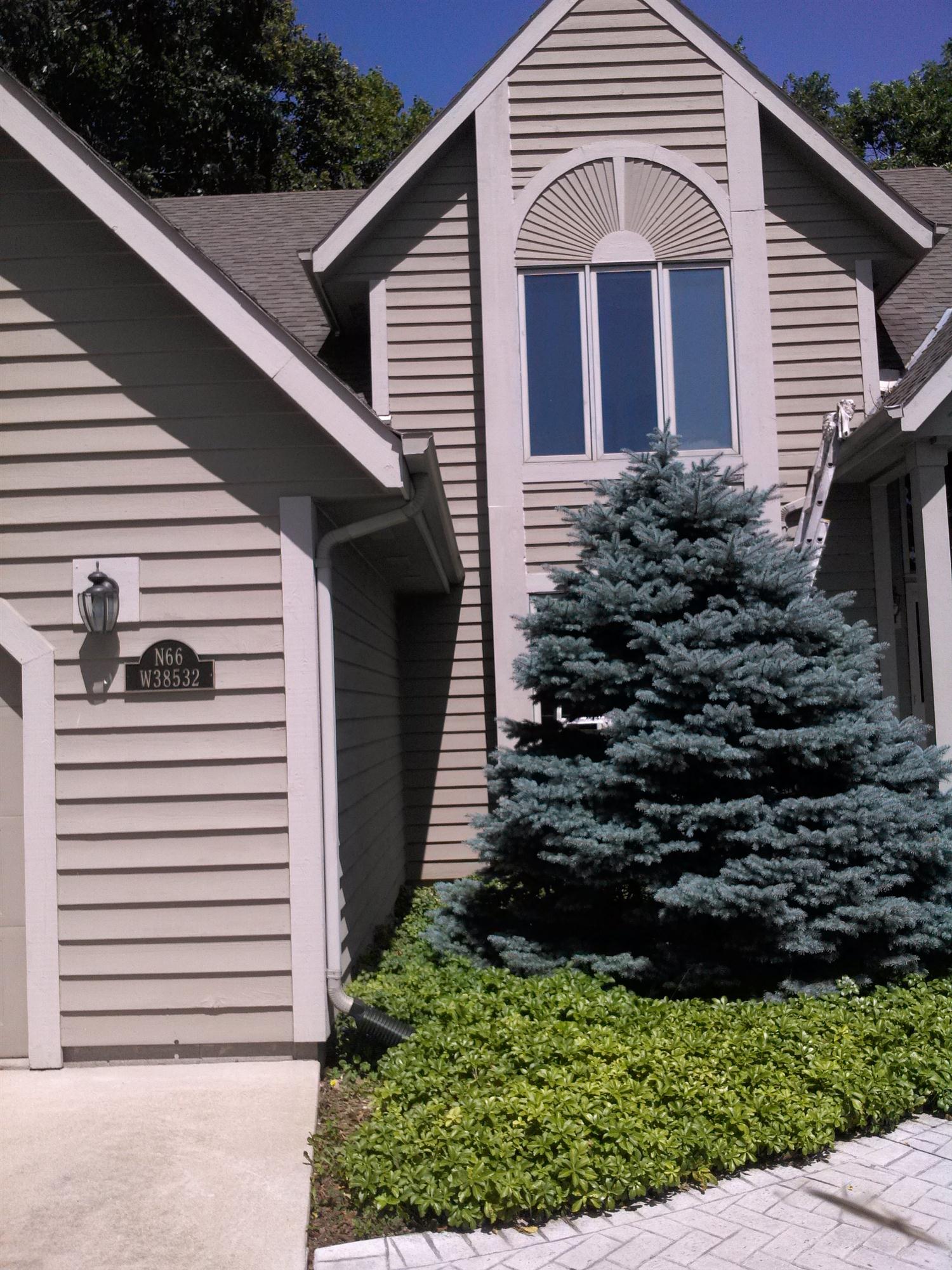 Flawless detail work on this home exterior Pewaukee painting contractors painted and refinished this Pewaukee home exterior